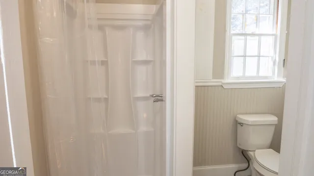 a white toilet sitting next to a white sink