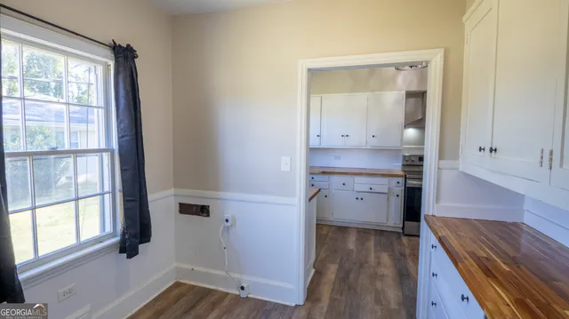a kitchen with white cabinets and a sink