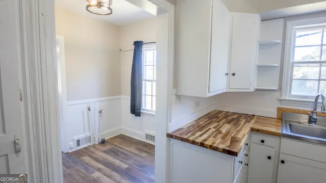 a kitchen with granite countertop a refrigerator and a sink