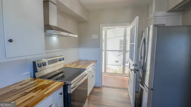 a kitchen with granite countertop a sink and a stove