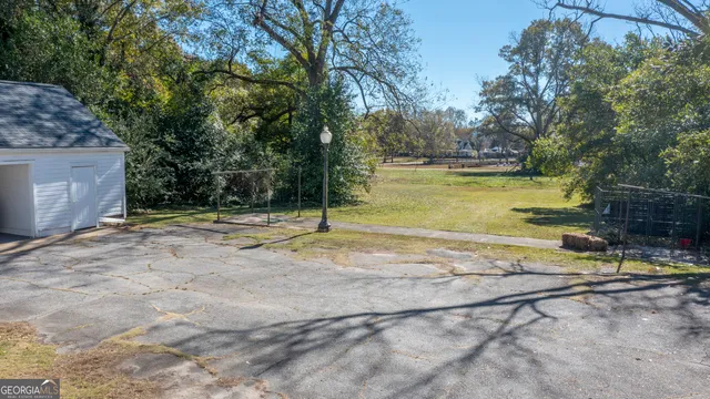 a view of a swimming pool with a patio and yard