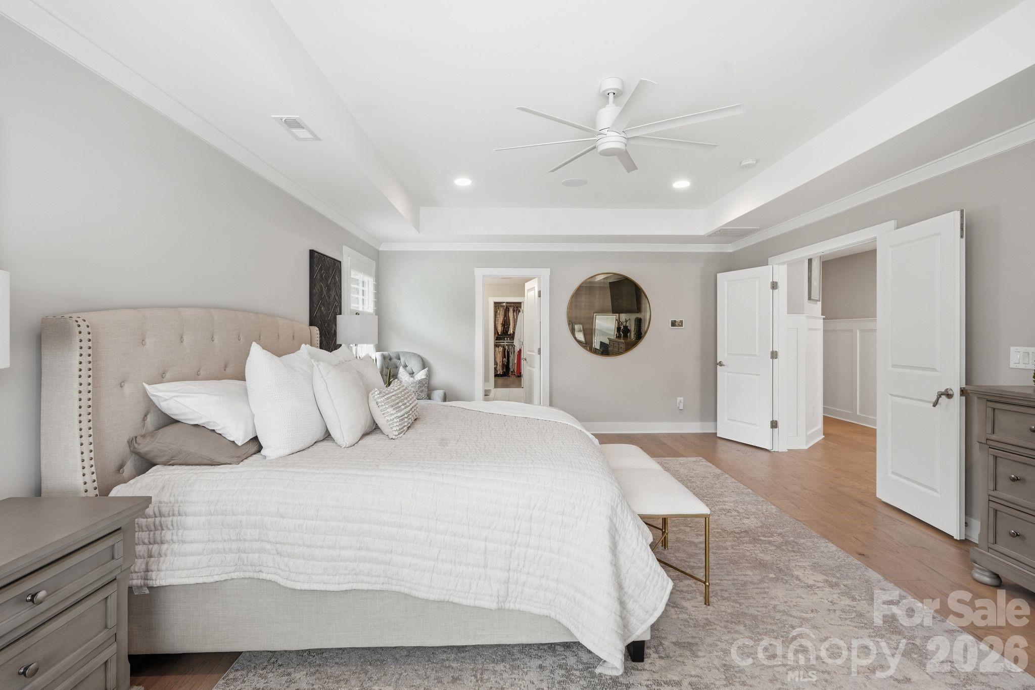 1086 Weir Court Fort Mill, SC 29708 - Photo 21 of 40 a bedroom with a large bed and a chandelier