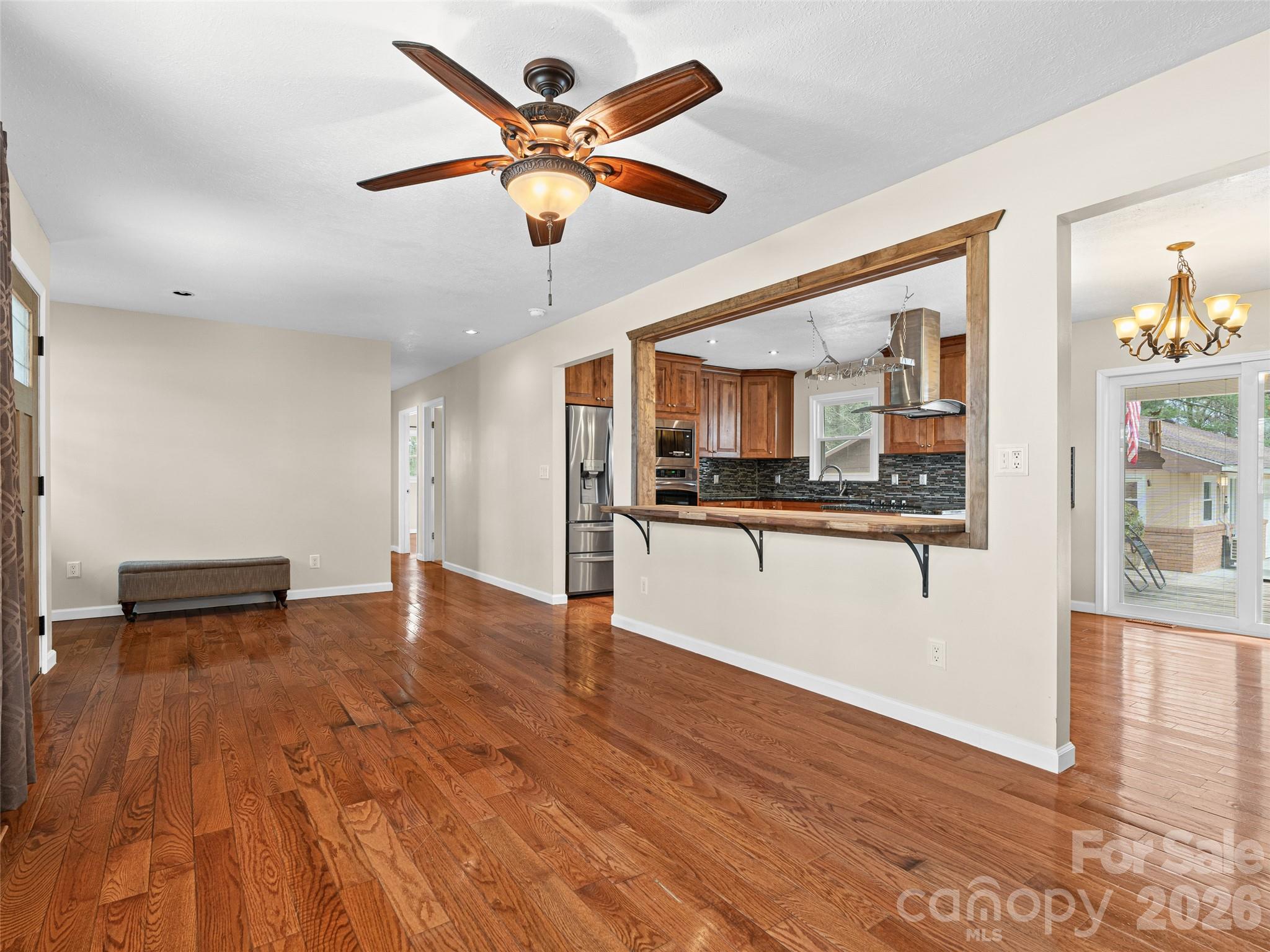1034 South Orchard Road Flat Rock, NC 28731 - Photo 11 of 30 a view of a kitchen with wooden floor and a ceiling fan