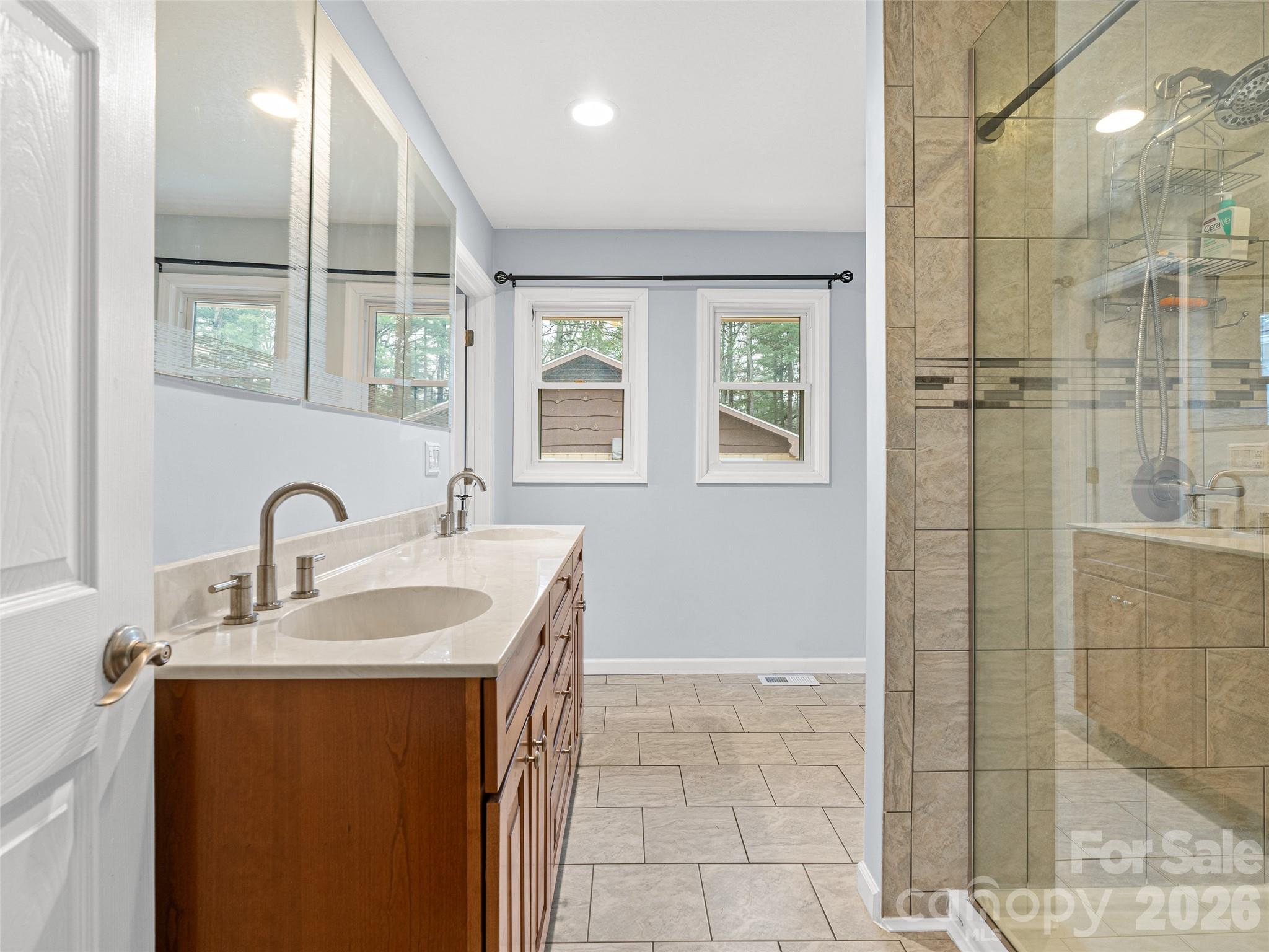 1034 South Orchard Road Flat Rock, NC 28731 - Photo 12 of 30 a bathroom with a double vanity sink window and shower