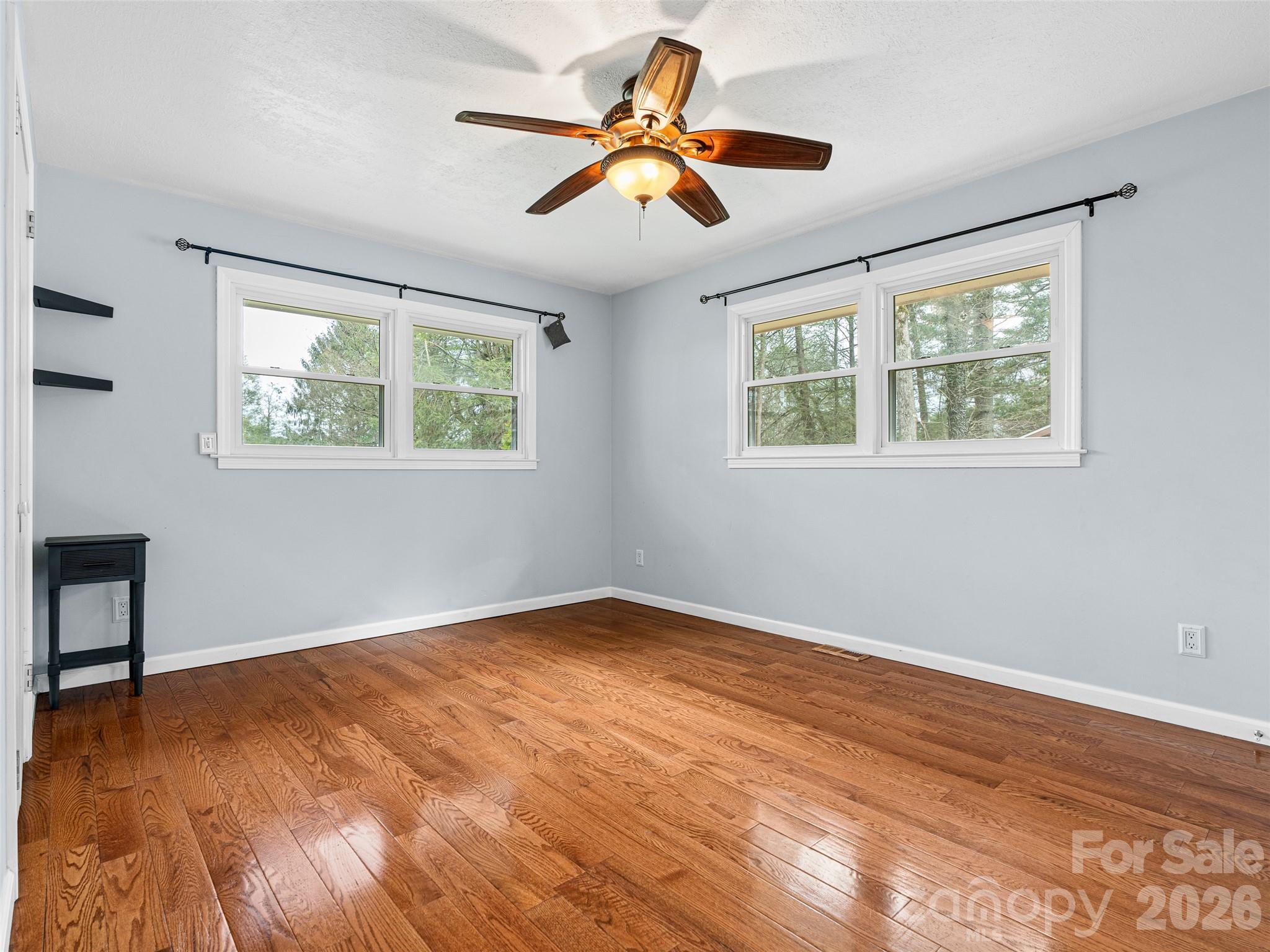 1034 South Orchard Road Flat Rock, NC 28731 - Photo 13 of 30 a view of an empty room with window and wooden floor