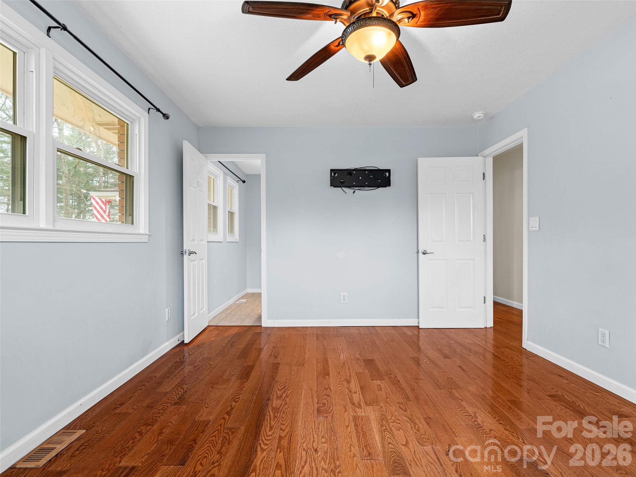 1034 South Orchard Road Flat Rock, NC 28731 - Photo 14 of 30 a view of an empty room with wooden floor and a window