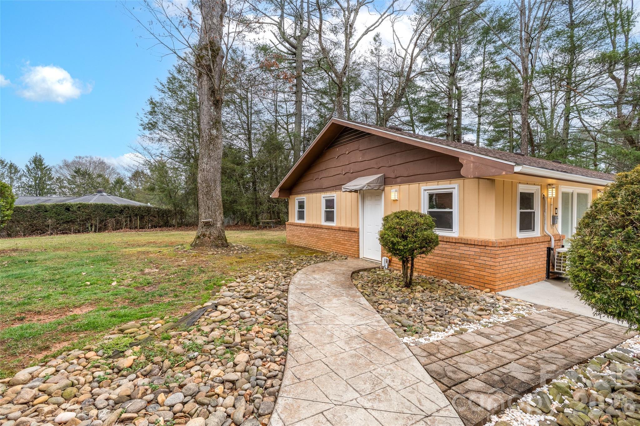 1034 South Orchard Road Flat Rock, NC 28731 - Photo 21 of 30 a view of a house with backyard and sitting area