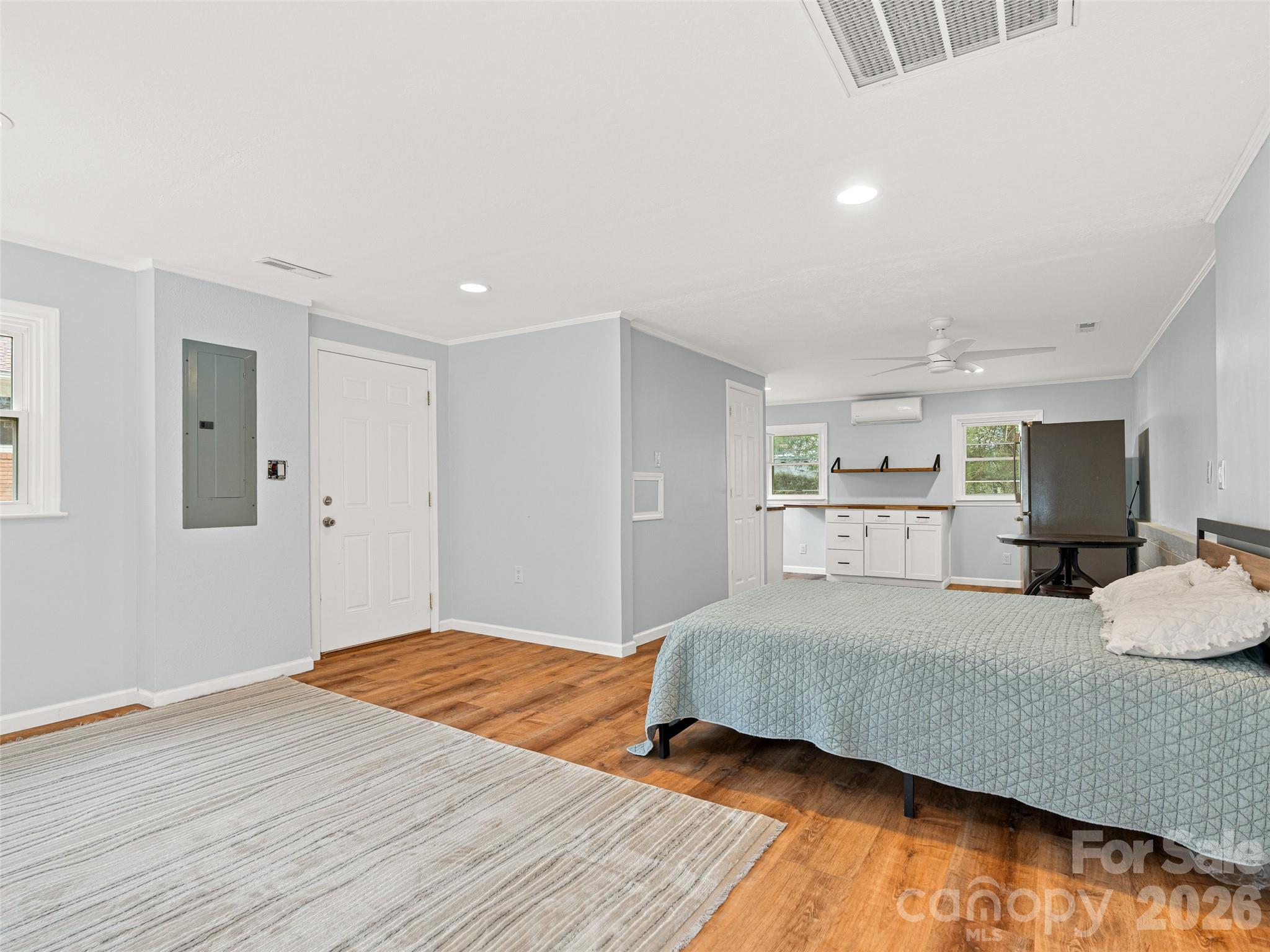 1034 South Orchard Road Flat Rock, NC 28731 - Photo 22 of 30 a bedroom with a large bed and a wooden floor
