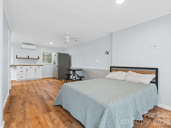 a bedroom with a bed and a flat screen tv