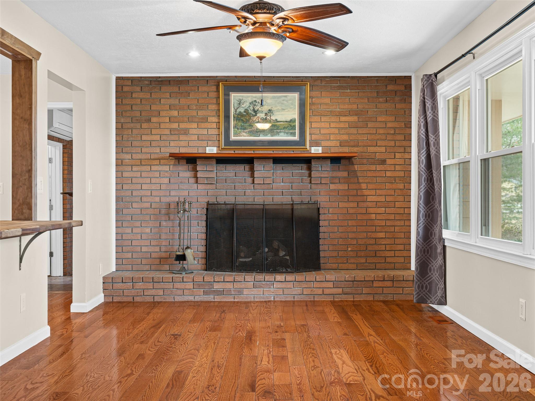1034 South Orchard Road Flat Rock, NC 28731 - Photo 10 of 30 an empty room with a fireplace and windows
