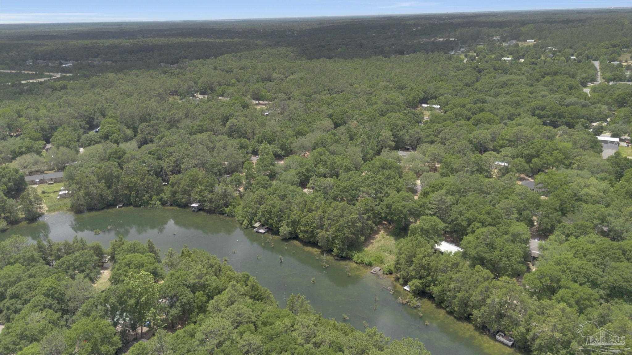 10290 West Lake Road Milton, FL 32583 - Photo 53 of 53 a view of a city with lush green forest