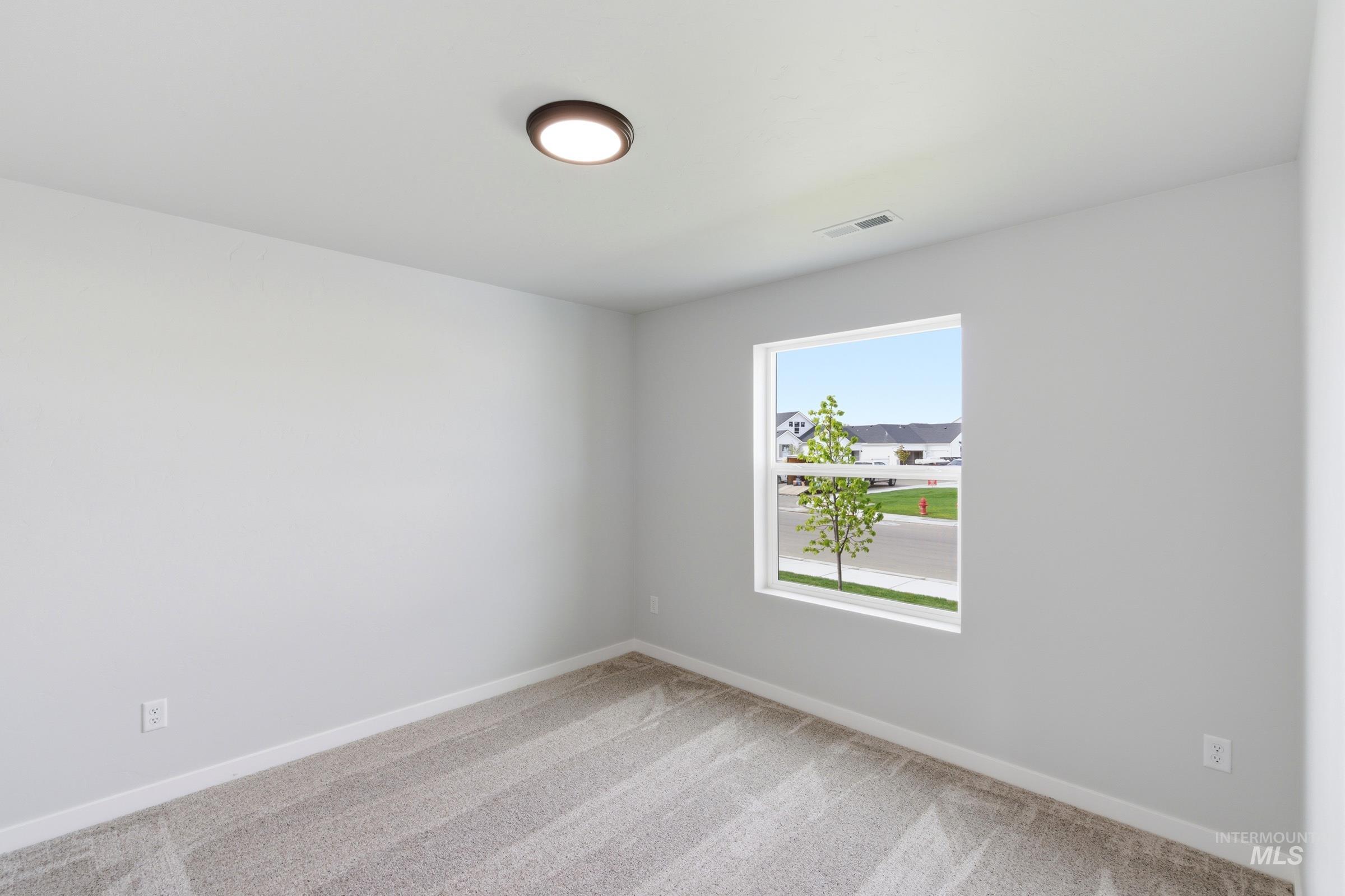 16558 Dunning Way Caldwell, ID 83607 - Photo 12 of 35 Room featuring light gray walls, plush carpet flooring, and a single window with white trim