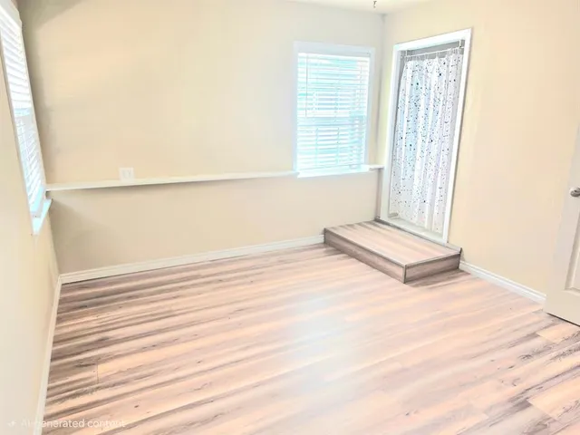 a view of wooden floor and windows in a room