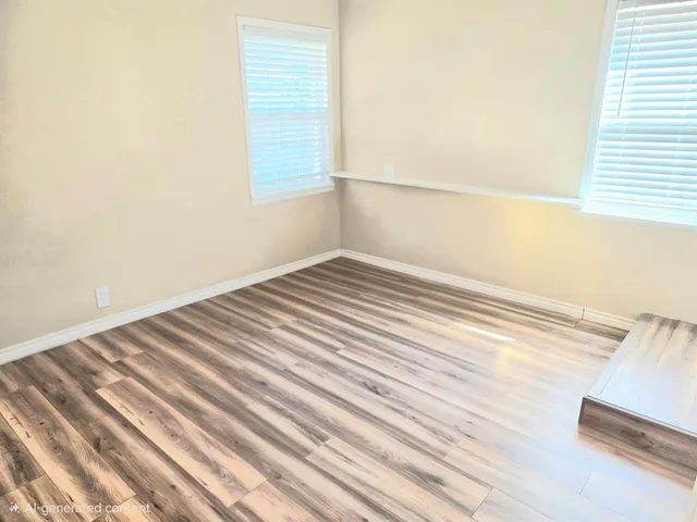 a view of a room with wooden floor and bench