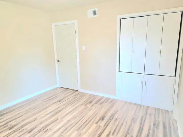 a view of a room with wooden floor