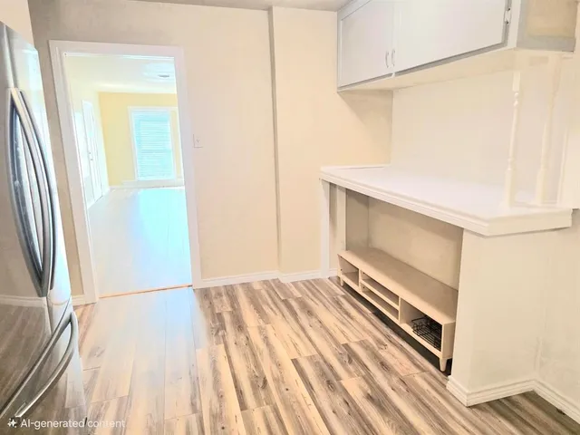 a view of an empty room and wooden floor