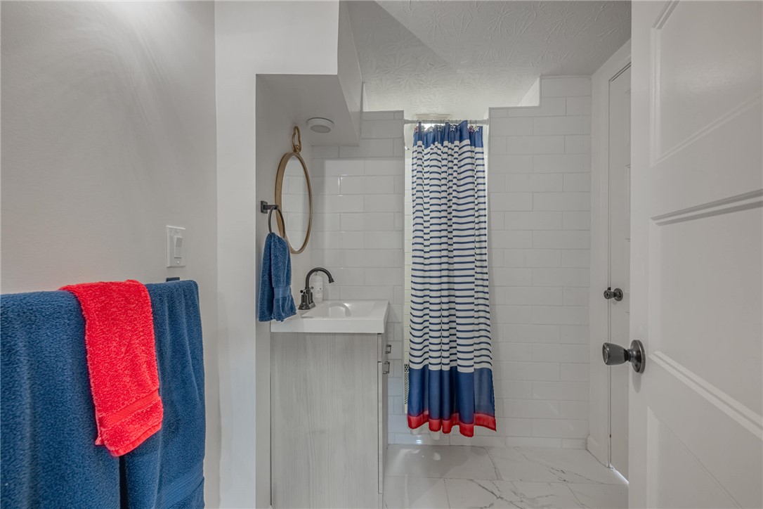 436 Marjorie Avenue Riverside, OH 45404 - Photo 24 of 34 This bathroom features pristine white subway tile and elegant marble-look flooring.