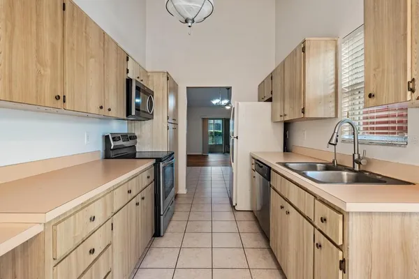 a kitchen with stainless steel appliances granite countertop a sink and cabinets