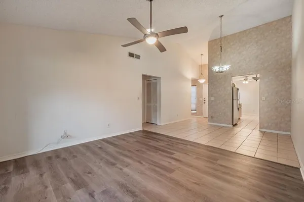 a view of an empty room with wooden floor