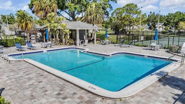 a view of a swimming pool with outdoor seating and a patio