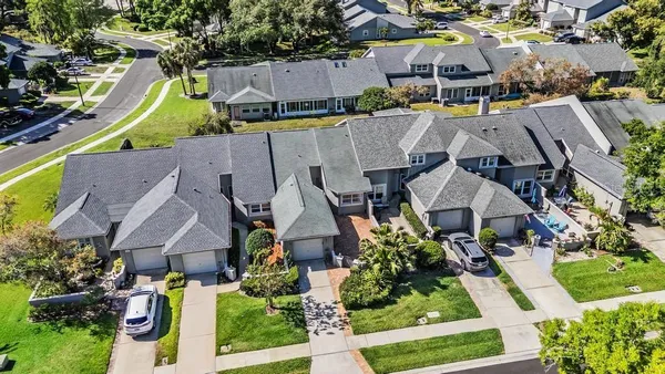 an aerial view of multiple houses with yard