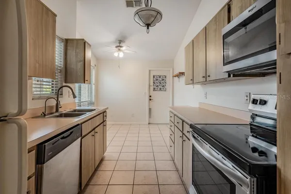 a kitchen with stainless steel appliances a sink stove and microwave