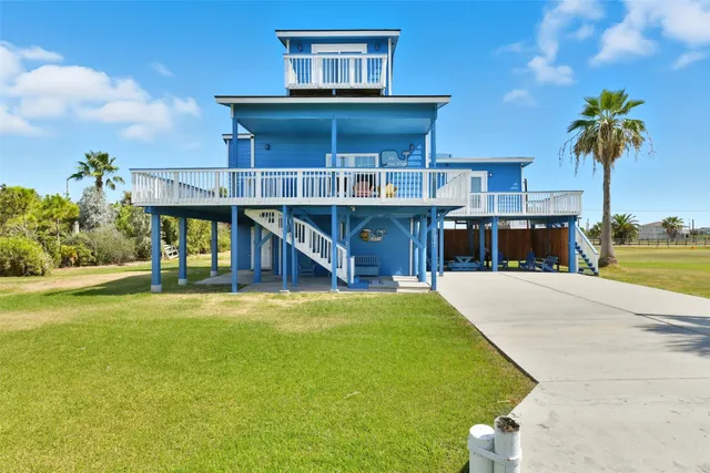 a view of a house with pool and a yard