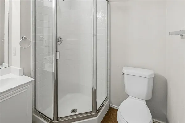 a white toilet sitting next to a bathroom sink