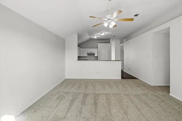 a view of a kitchen with a sink and cabinet with a ceiling fan