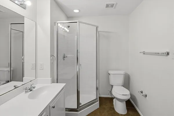 a bathroom with a toilet sink shower and mirror