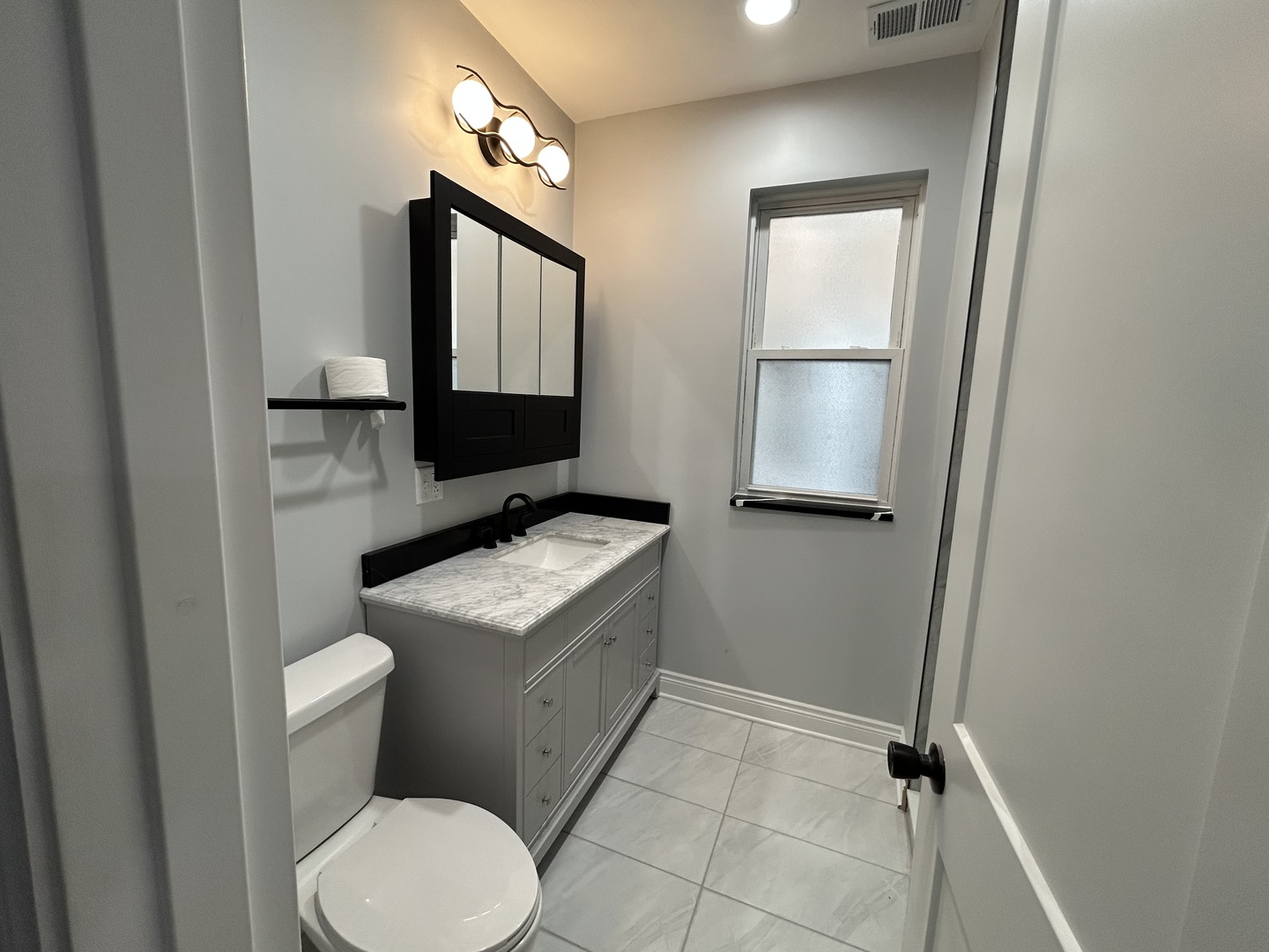 7940 South Carpenter Street, Unit 2 Chicago, IL 60620 - Photo 27 of 34 a bathroom with a toilet sink and mirror