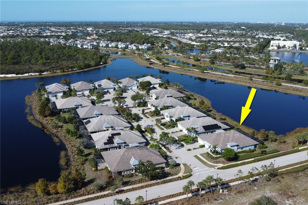 6809 Bequia Way Naples, FL 34113 - Photo 34 of 49 Aerial view of property and surrounding area featuring a large body of water