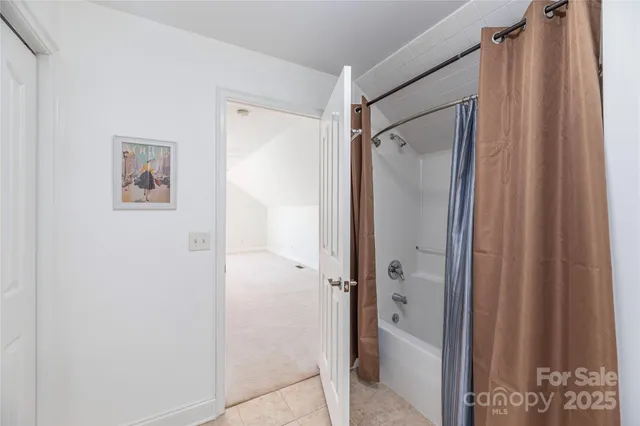 a bathroom with a shower and a glass door