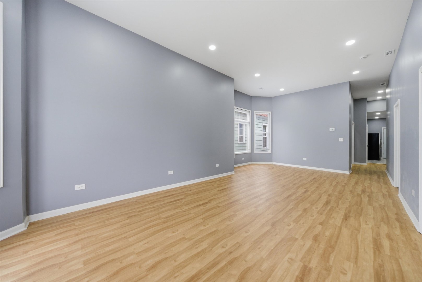 7828 South Escanaba Avenue Chicago, IL 60649 - Photo 5 of 41 a view of empty room with wooden floor and fan