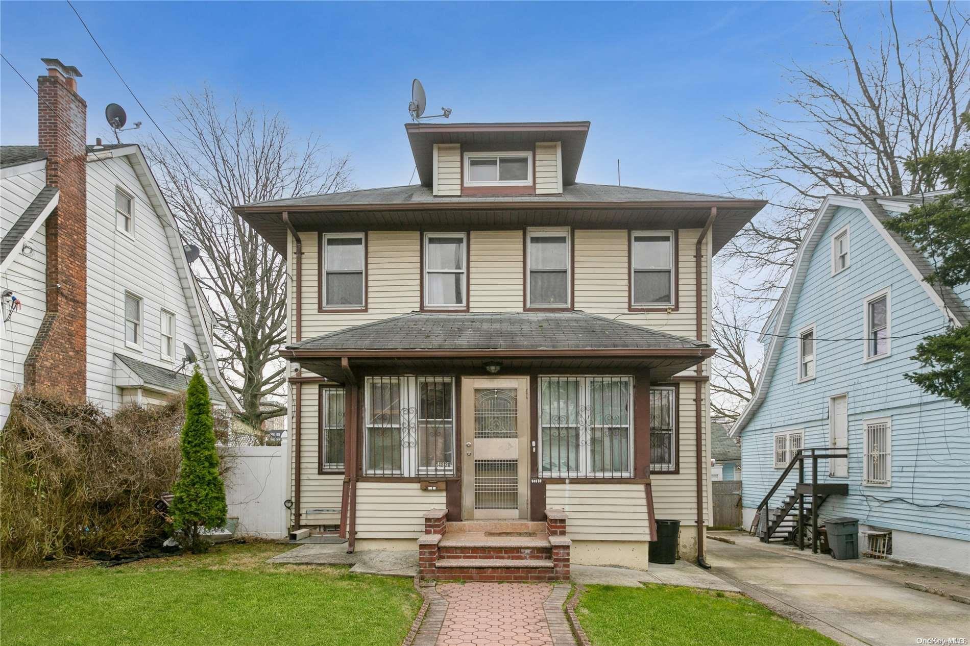 148-38 86th Avenue Queens, NY 11435 - Photo 1 of 1 a front view of a house with garden
