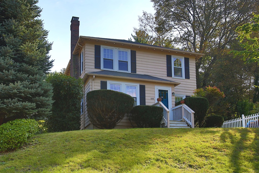 199-201 Langley Road, Unit 201 Newton, MA 02459 - Photo 2 of 5 a view of a house with a backyard and a tree