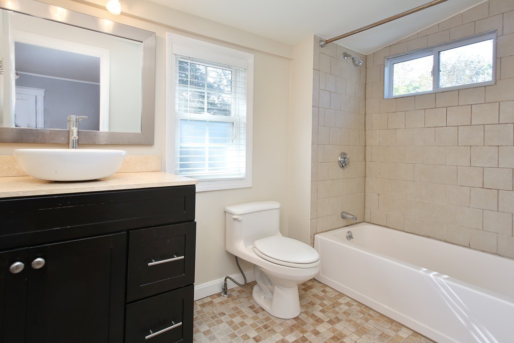 199-201 Langley Road, Unit 201 Newton, MA 02459 - Photo 5 of 5 a bathroom with a sink a toilet and shower