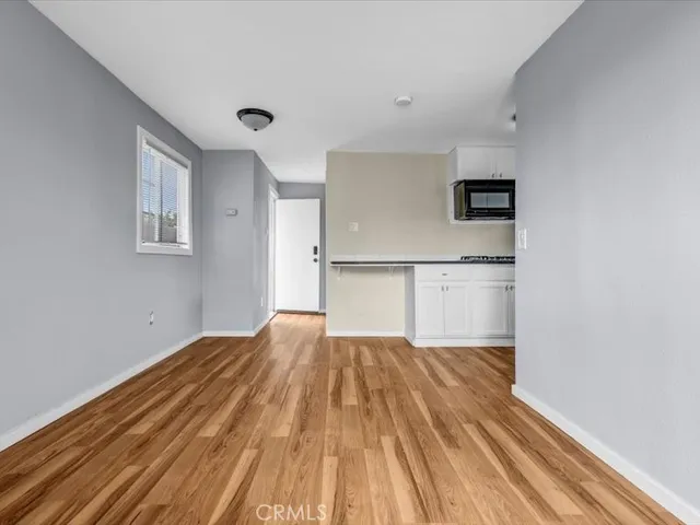 a view of a kitchen with wooden floor and a sink