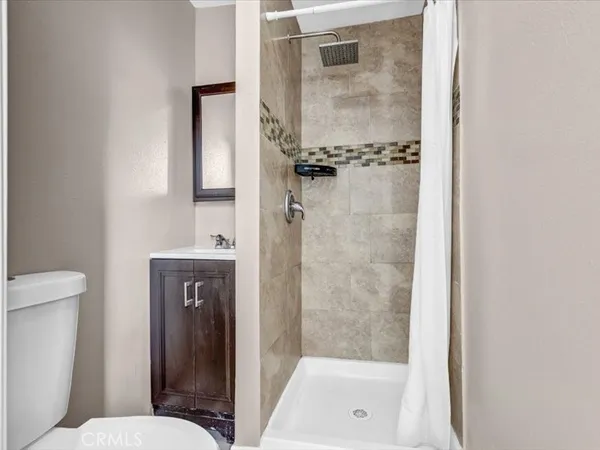 a bathroom with a shower and toilet