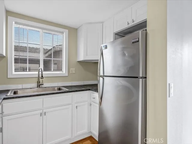 a kitchen with a refrigerator and a sink
