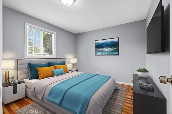 a bedroom with bed and a flat screen tv