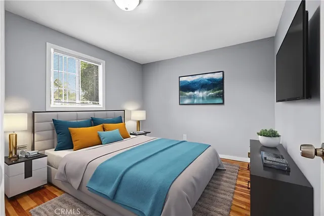 a bedroom with bed and a flat screen tv