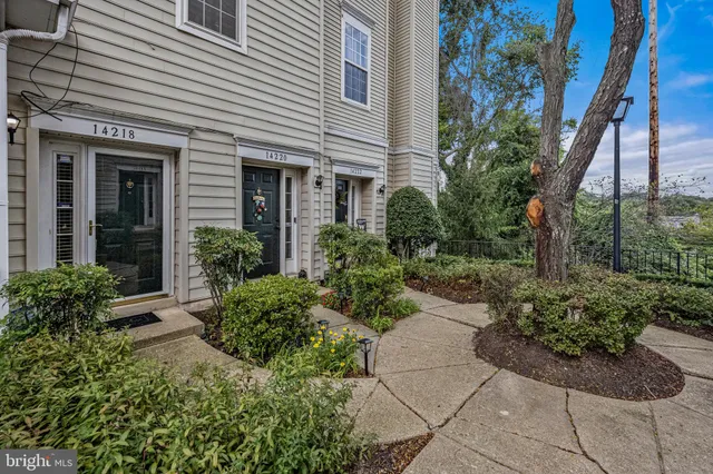 a view of a house with potted plants