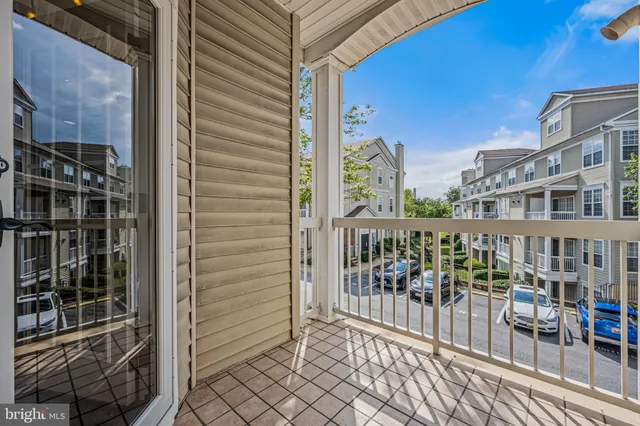 a balcony with furniture and a potted plant