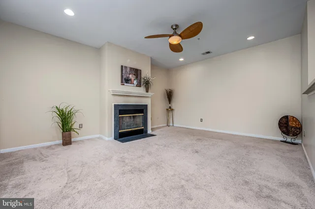 an empty room with windows and flowerpot