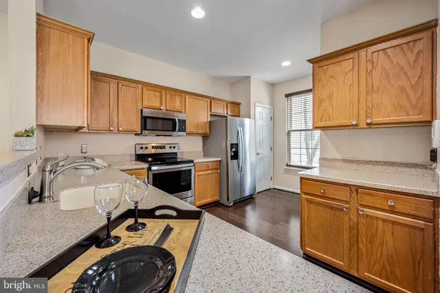 a kitchen with a sink a stove and a microwave