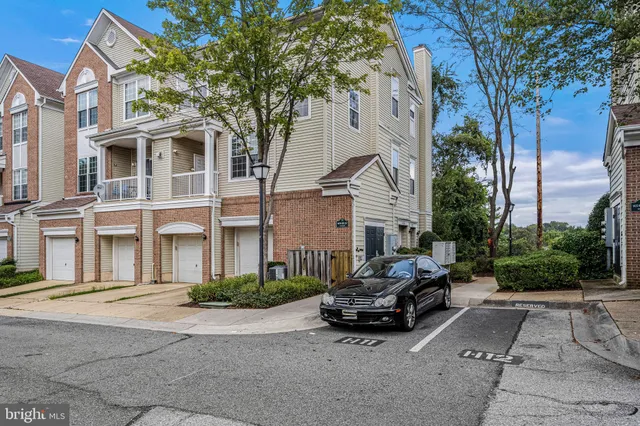 a car parked in front of a white house