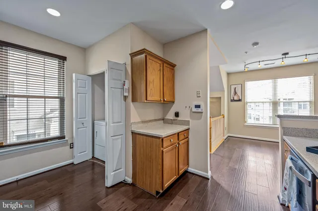 a view of a kitchen with wooden floor and electronic appliances