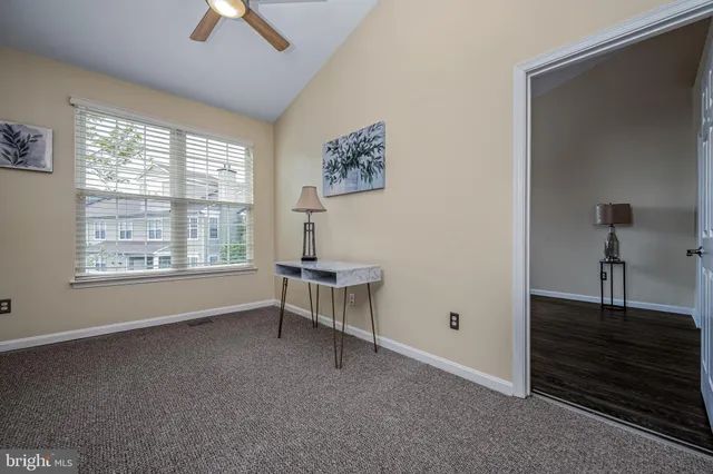 a view of workspace with window and a ceiling fan