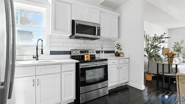 a kitchen with a sink stove and microwave